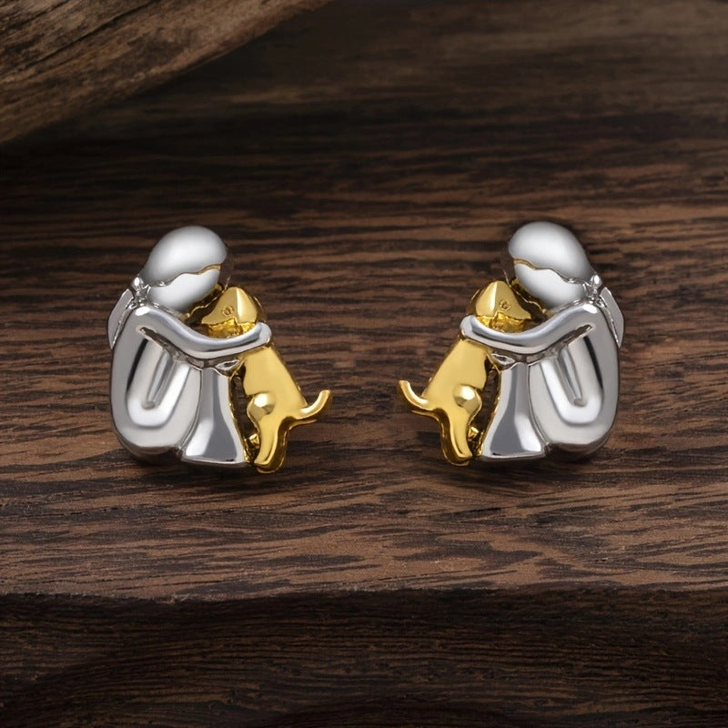 A little girl and a dog embrace earrings